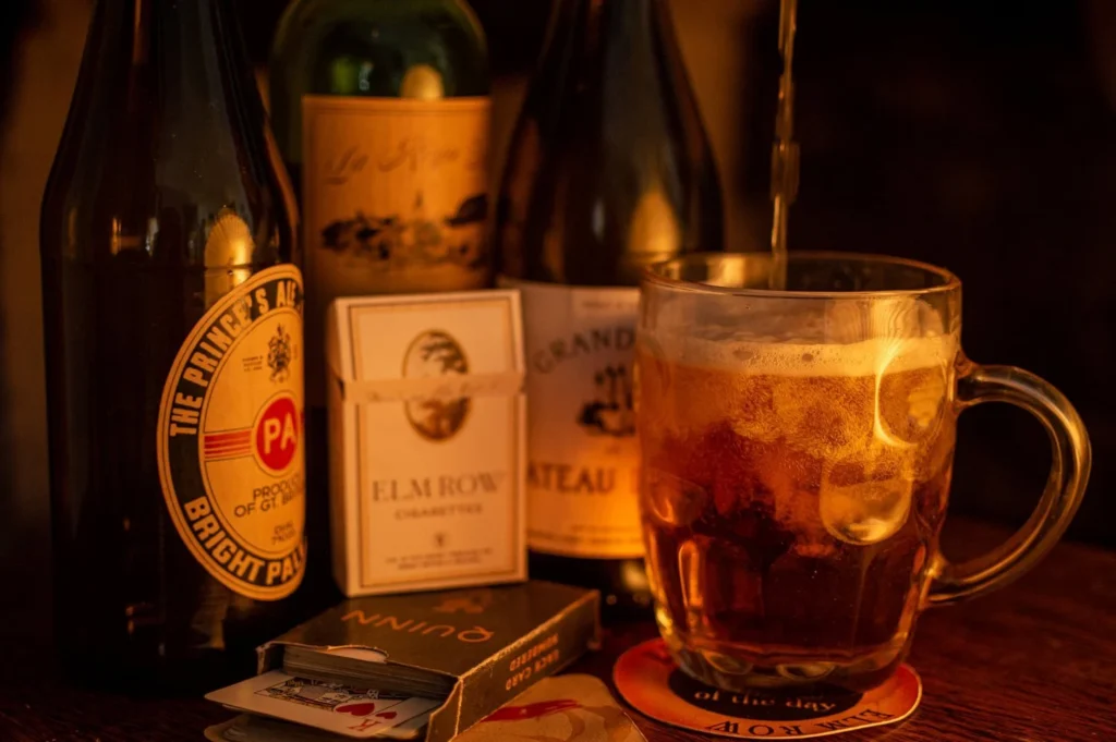 Period props: Beer, cigarettes, and playing cards on a table
