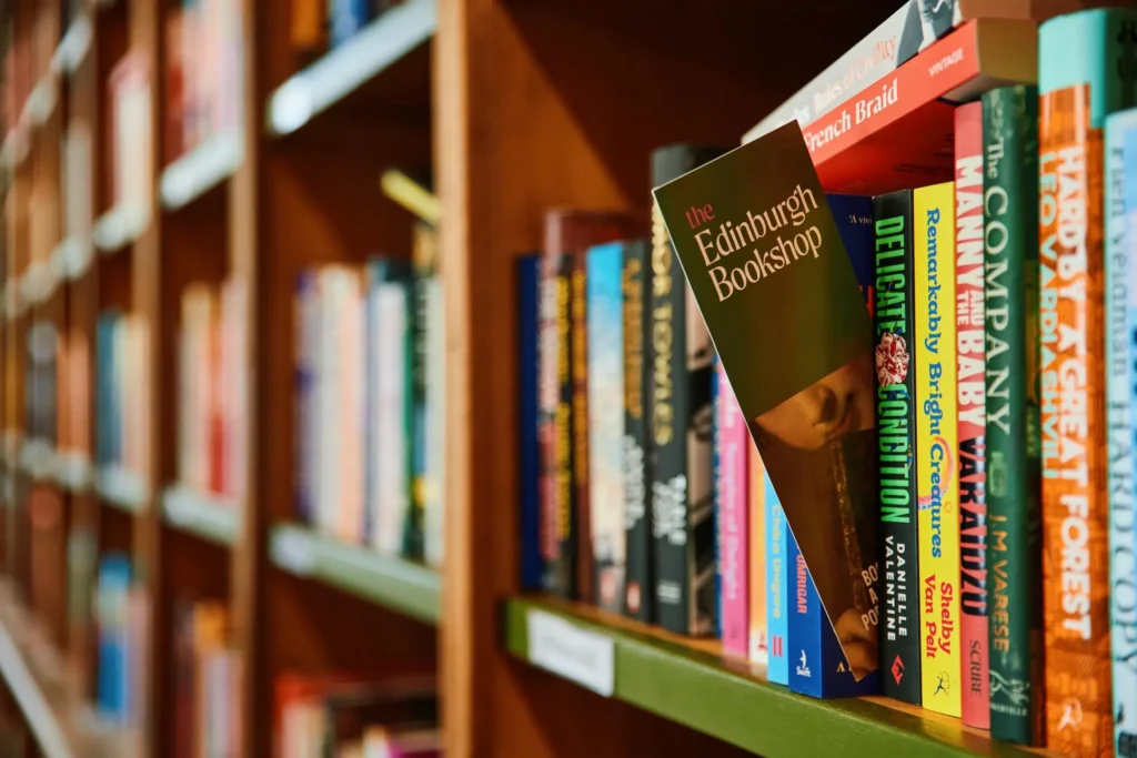 The Edinburgh Bookshop: Books on a shelf, with "The Edinburgh Bookshop" title visible.