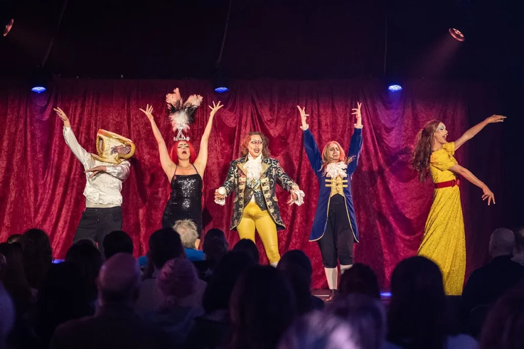 Performers in elaborate costumes on stage at Underbelly Festival Cavendish Square