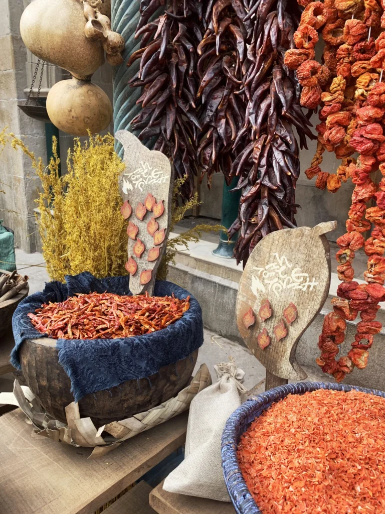Dried chili peppers and gourds for sale at a market stall