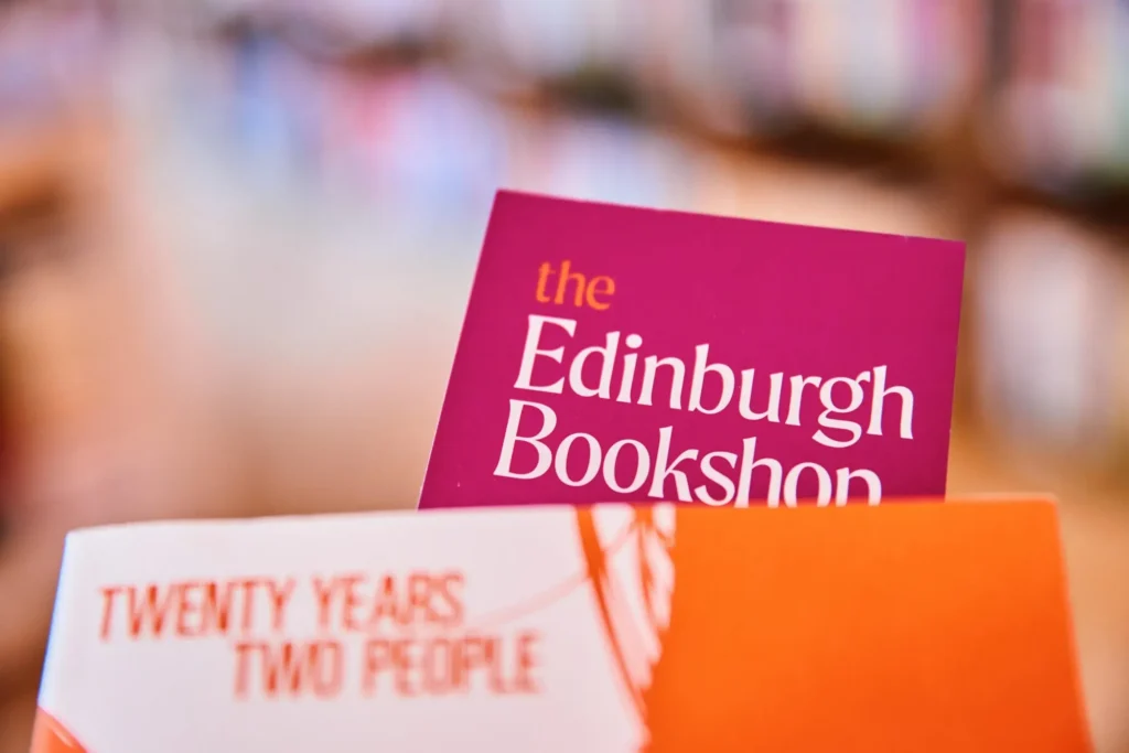 The Edinburgh Bookshop sign and "Twenty Years, Two People" book cover