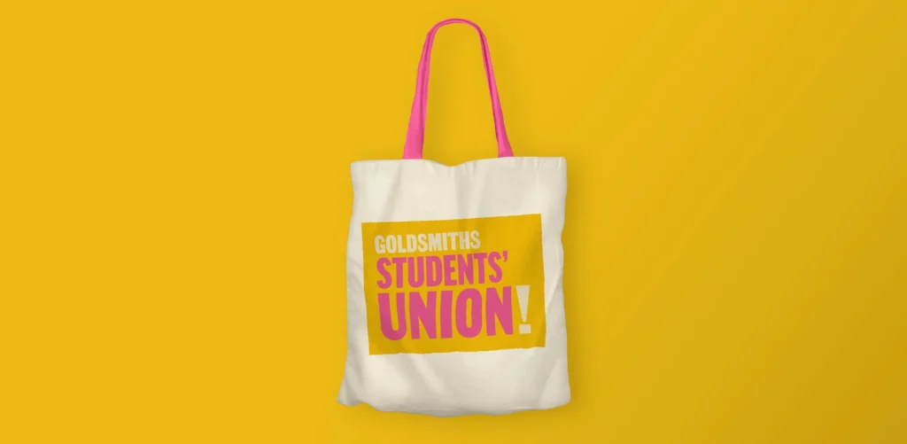 Goldsmiths Students' Union tote bag with pink handles and yellow logo