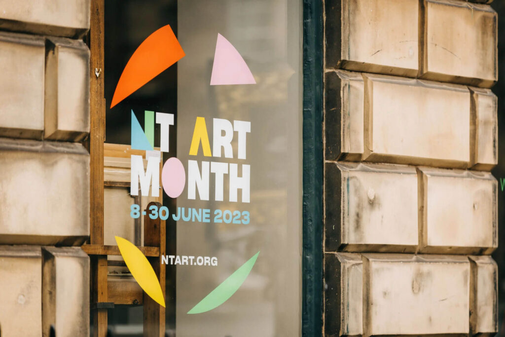 New Town Art Month poster with dates 8-30 June 2023 on a window