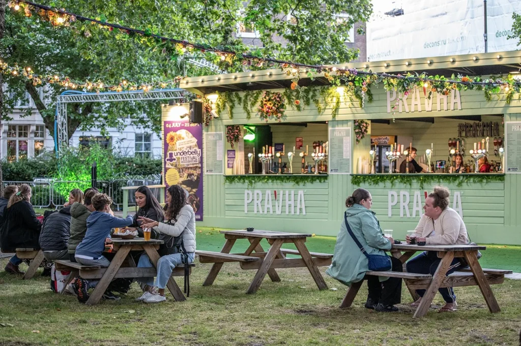 People enjoy drinks at Underbelly Festival Cavendish Square outdoor bar