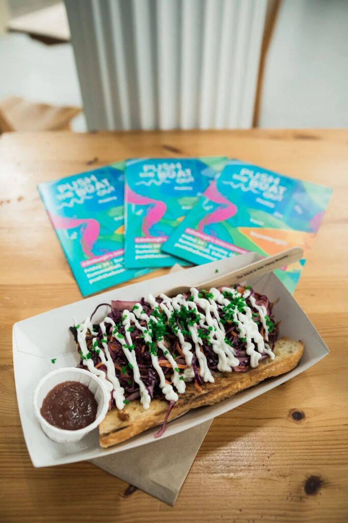 Push the Boat Out 2023 event flyer with a gourmet hot dog