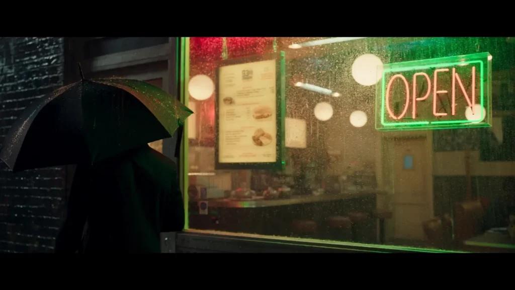 Person with umbrella enters diner with "OPEN" neon sign in Secret Invasion.