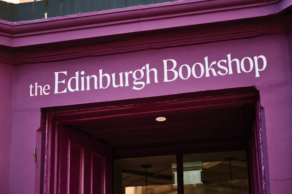 The Edinburgh Bookshop sign above a deep purple doorway.