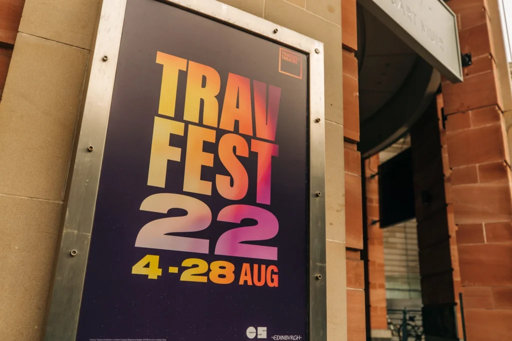 TravFest 2022 poster with dates 4-28 Aug on a building exterior