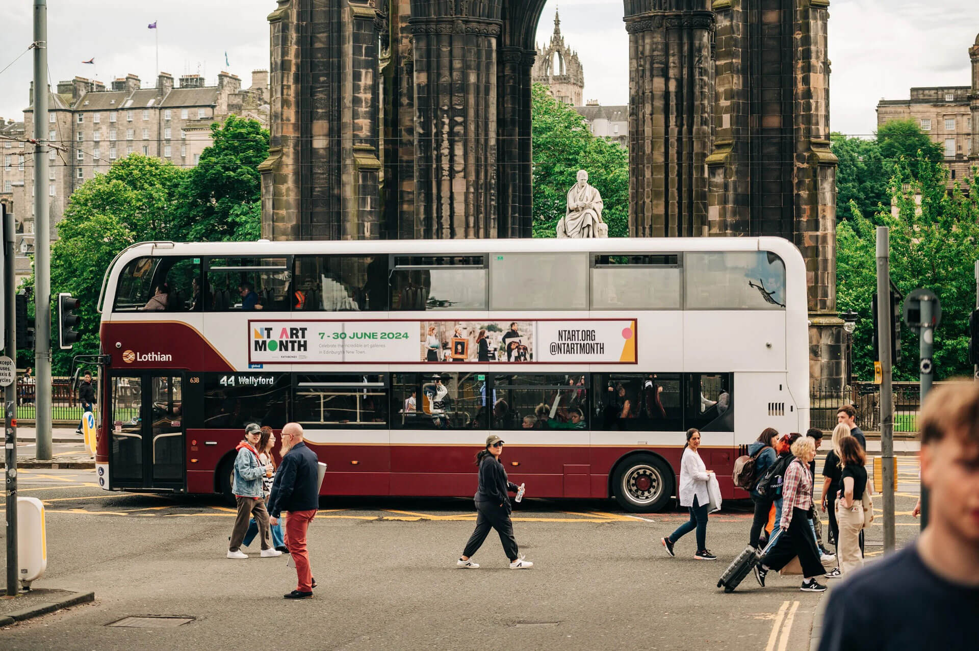 Double-decker bus in Edinburgh with "NT ART MONTH" promotion