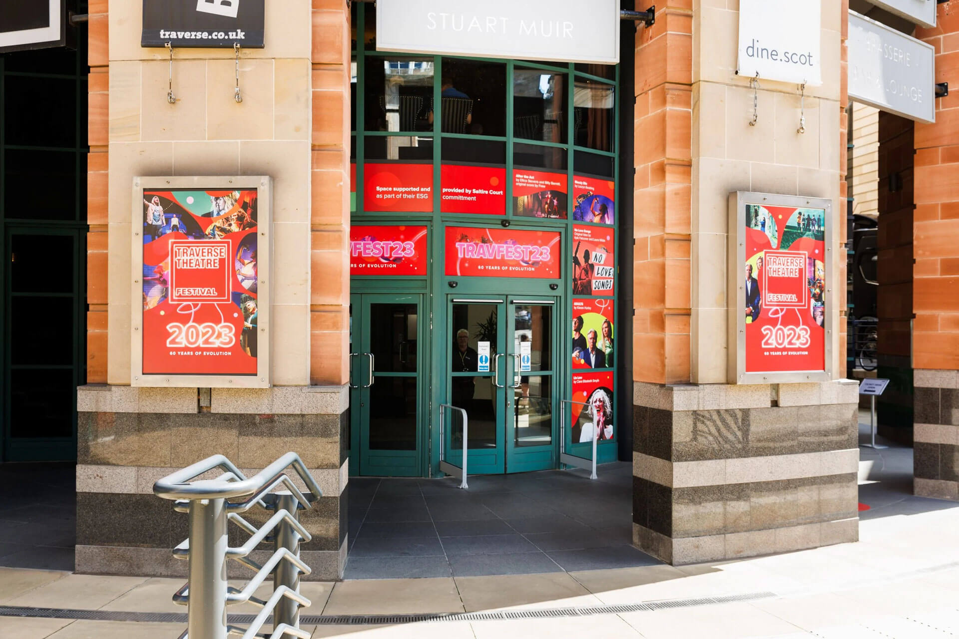 Traverse Theatre entrance with "Fest 23" posters and "Traverse Theatre Festival" banners