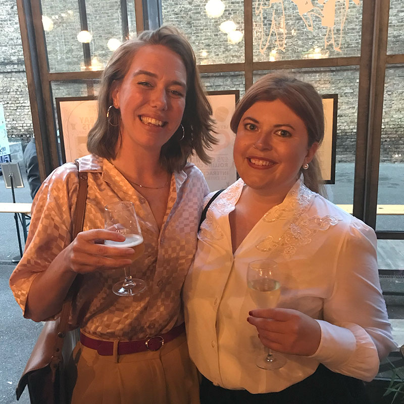 Laura Whitehouse, freelance graphic designer, with a colleague at an event.