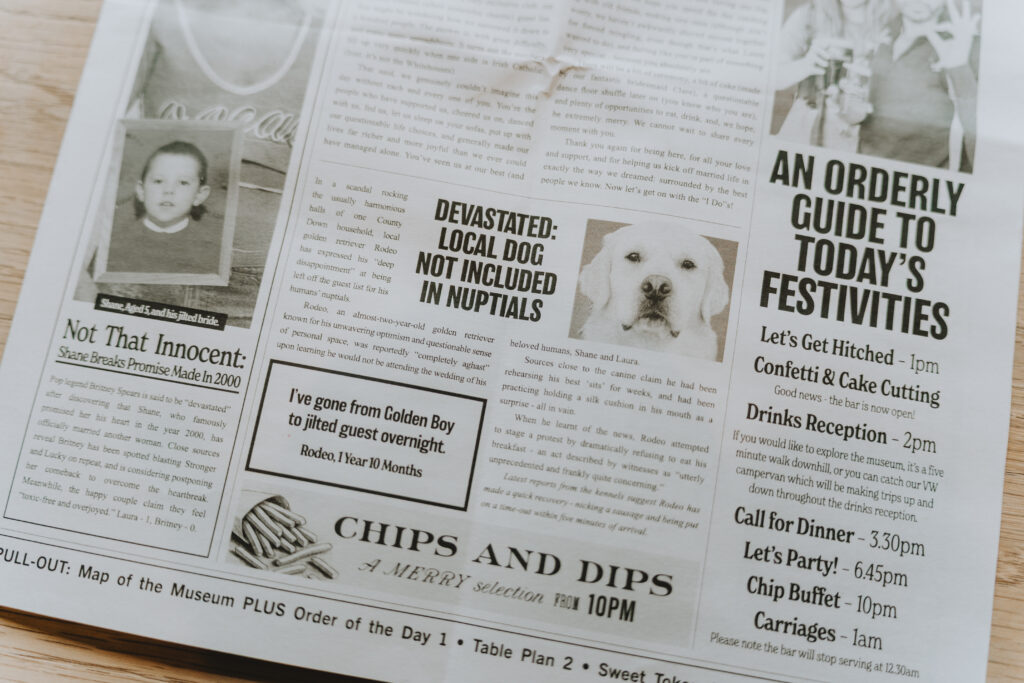 Newspaper clipping with headline "DEVISTATED: LOCAL DOG NOT INCLUDED IN NUPTIALS" and image of golden retriever
