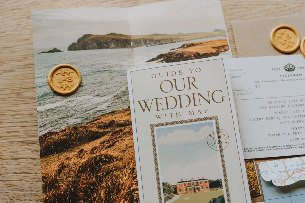 Wedding invitation suite with a scenic landscape photo and wax seals.